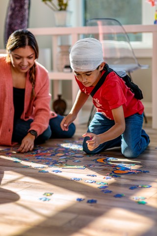 boy playing with puzzle after brain surgery