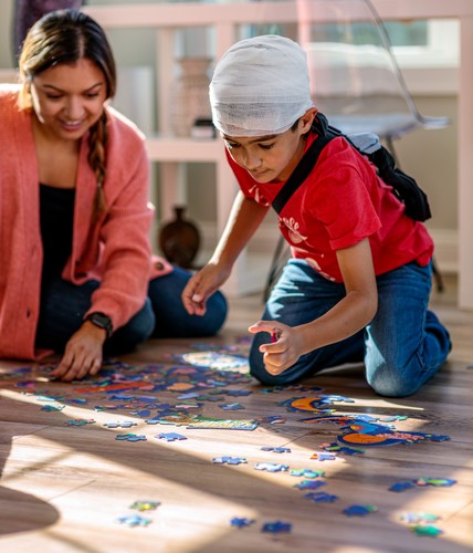 boy playing with puzzle after brain surgery