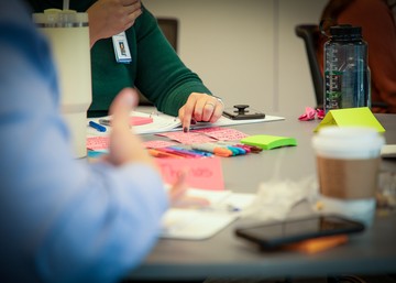 hands in a meeting with a colorful background