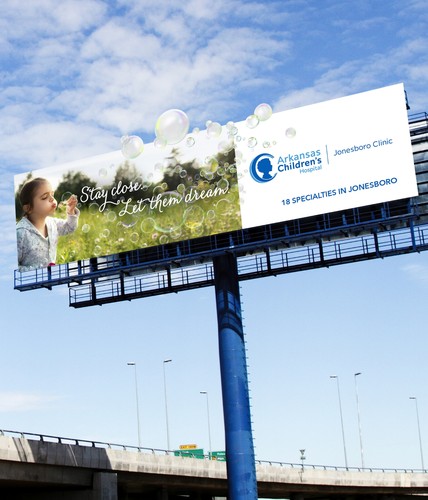 billboard of ad showing a girl blowing bubbled