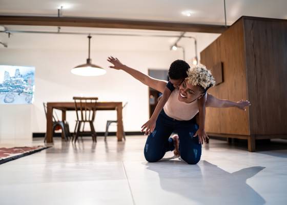 woman playing with her daughter in the kitchen