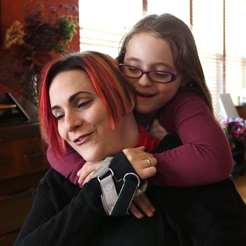 Alaina getting a hug from a friend.