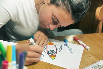 picture of girl drawing a rocket ship