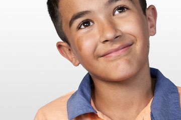 picture of little boy looking off to the side, smiling