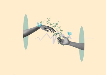 two hands meeting with growing flowers around them