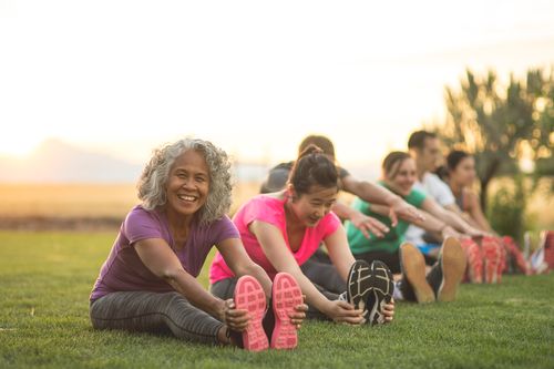 people sitting outside in a park at golden hour