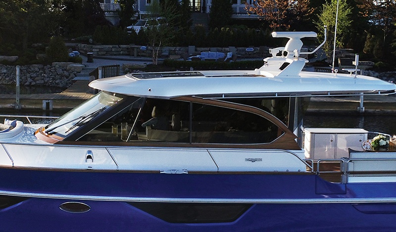 Burger Boat's "Cruiser" on the lake with house in background