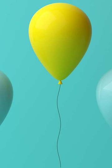 a row of blue balloons with one yellow balloon standing out