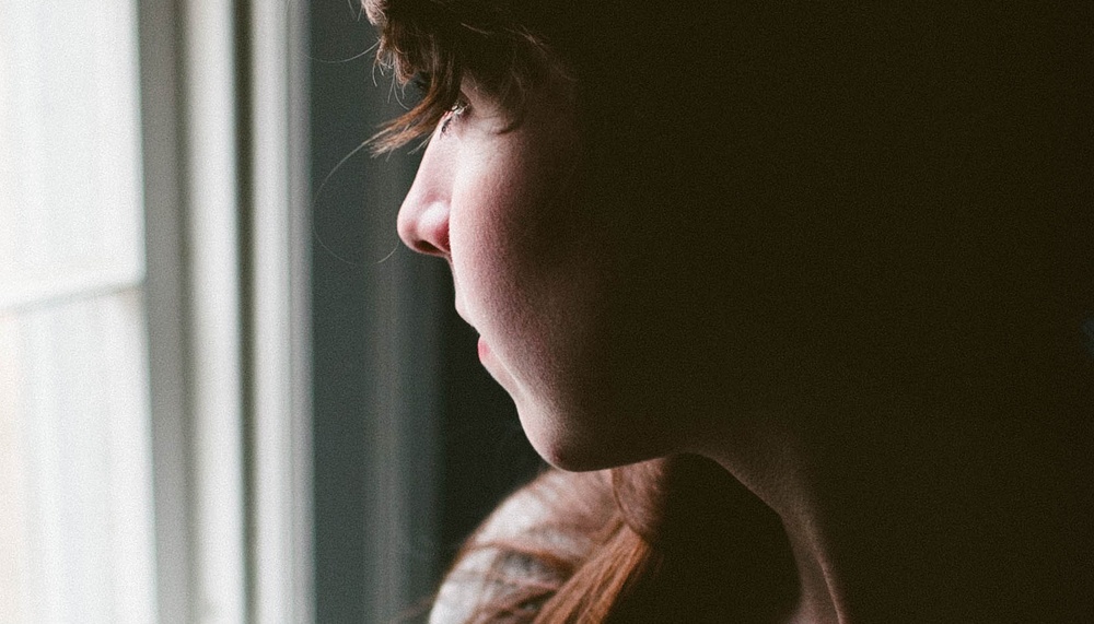 person looking out of window