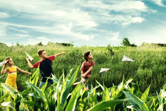 kids throwing paper airplanes