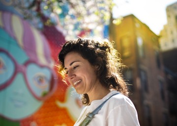 woman painting a colorful mural