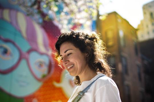 woman painting a colorful mural