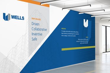 Wells branded wall "Our Values: Driven, Collaborative, Inventive, Safe" and mission and Vvsion statements