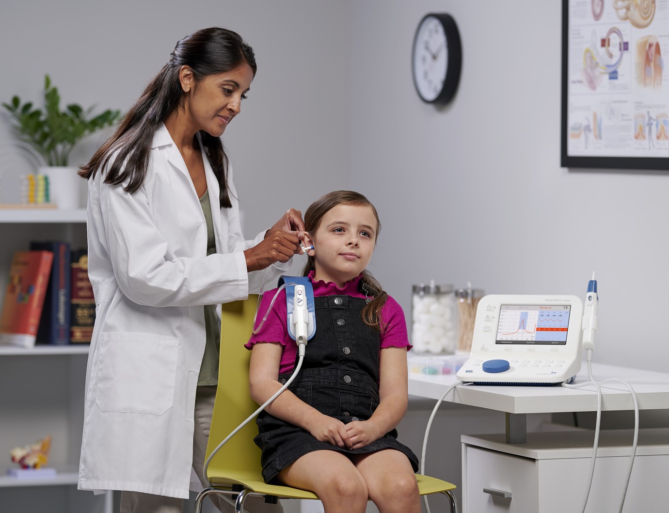 physician using Natus technology on a little girl