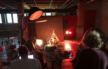 A Core photoshoot with children in a small tent adorned with lights.