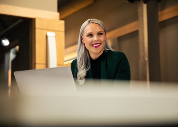 Smiling woman with a laptop.