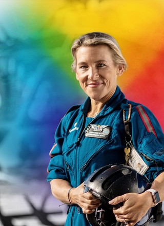 ThedaCare featured helicopter pilot with colorful logo behind her