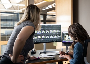 CORE Brand team collaborating at a desk.