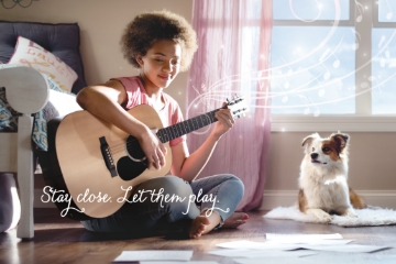 'Let Them Play' - Ad video shoot with a girl playing guitar with a dog smiling next to her.