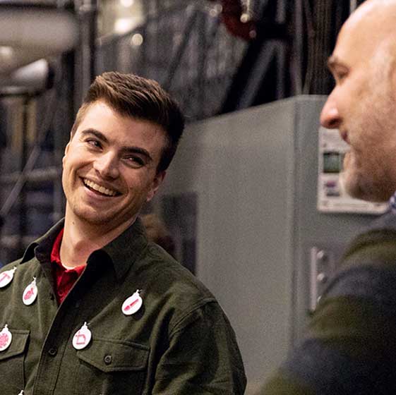 Two Core employees having a great time talking at the holiday party