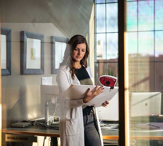 A Core Employee looking at documents for a client.