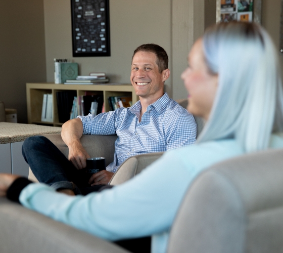 A man smiling during a CORE Welcomes committe meeting.